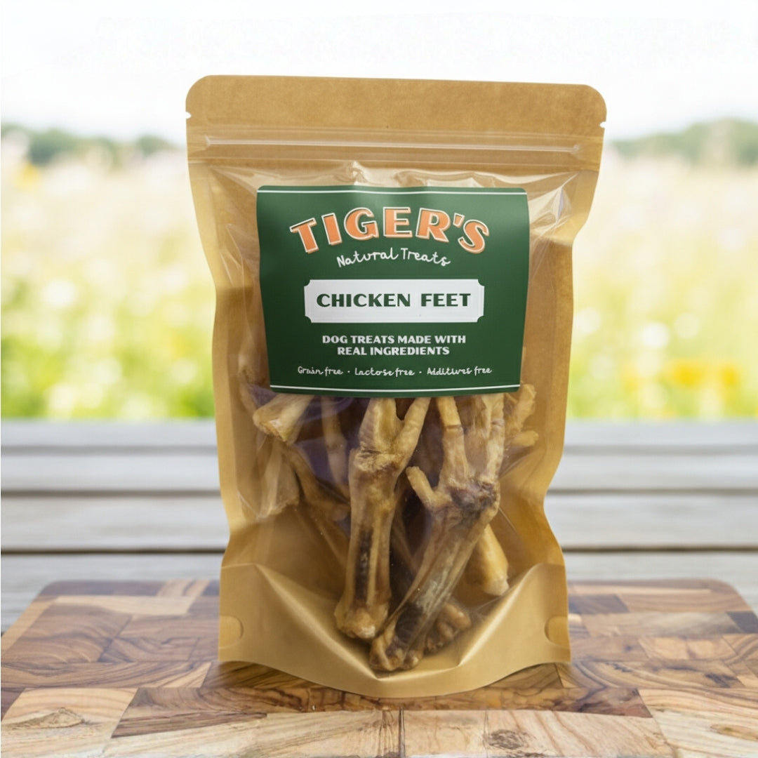 Bag of Tiger's Natural Treats Chicken Feet on a wooden surface with a blurred outdoor background