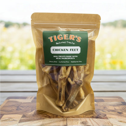 Bag of Tiger's Natural Treats Chicken Feet on a wooden surface with a blurred outdoor background